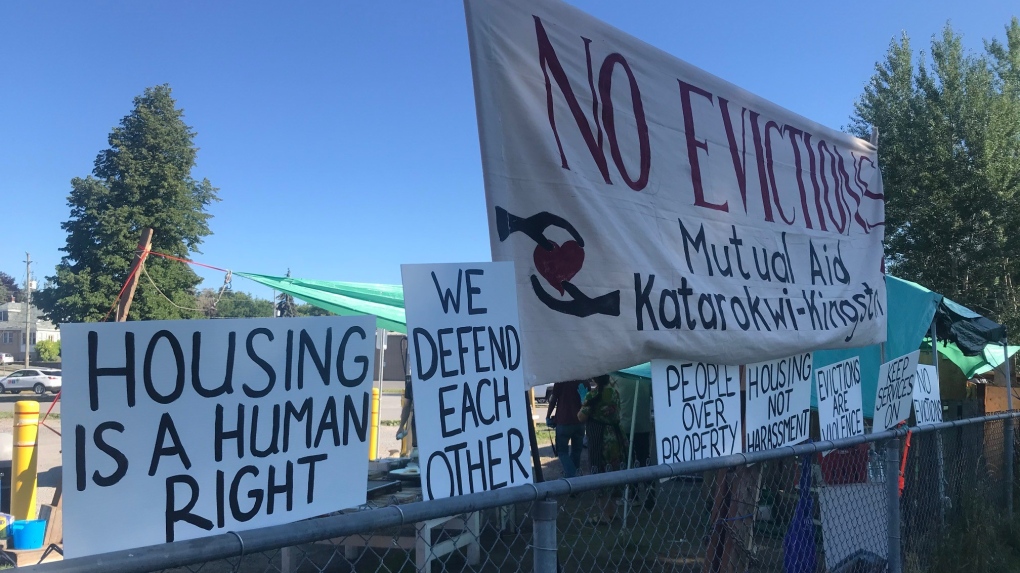 Signs at a temporary campsite at Belle Park in Kingston, calling on the City to find proper housing solutions for the campers. (Kimberley Johnson / CTV News Ottawa)