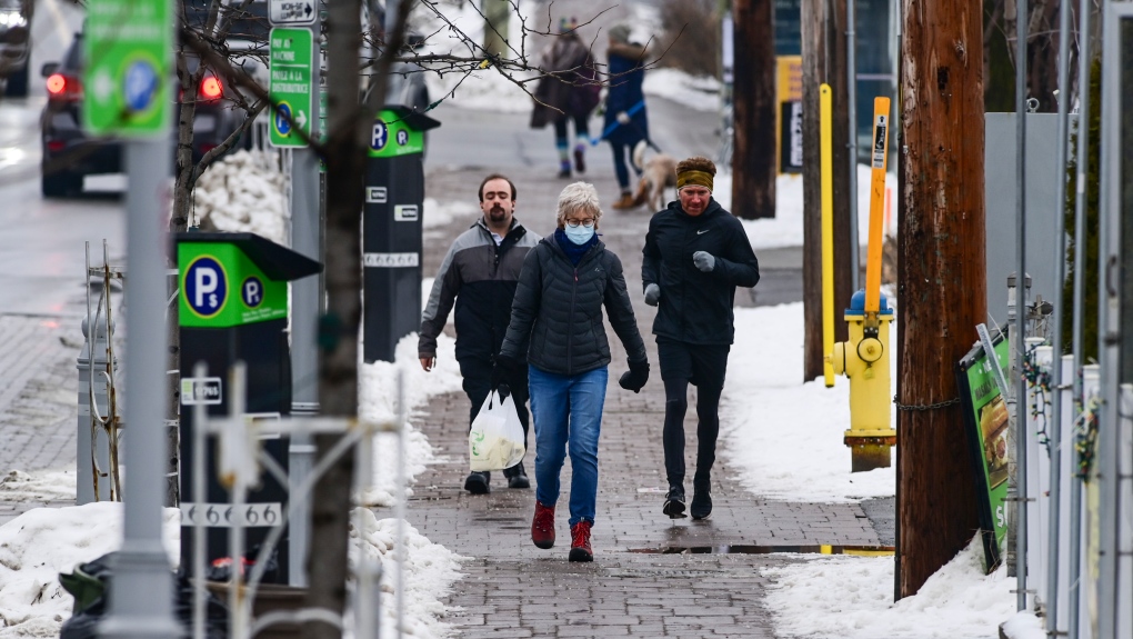People make their way along Somerset Street during the first day of the Ontario stay home order in Ottawa on Thursday, Jan. 14, 2021. (Sean Kilpatrick/THE CANADIAN PRESS)