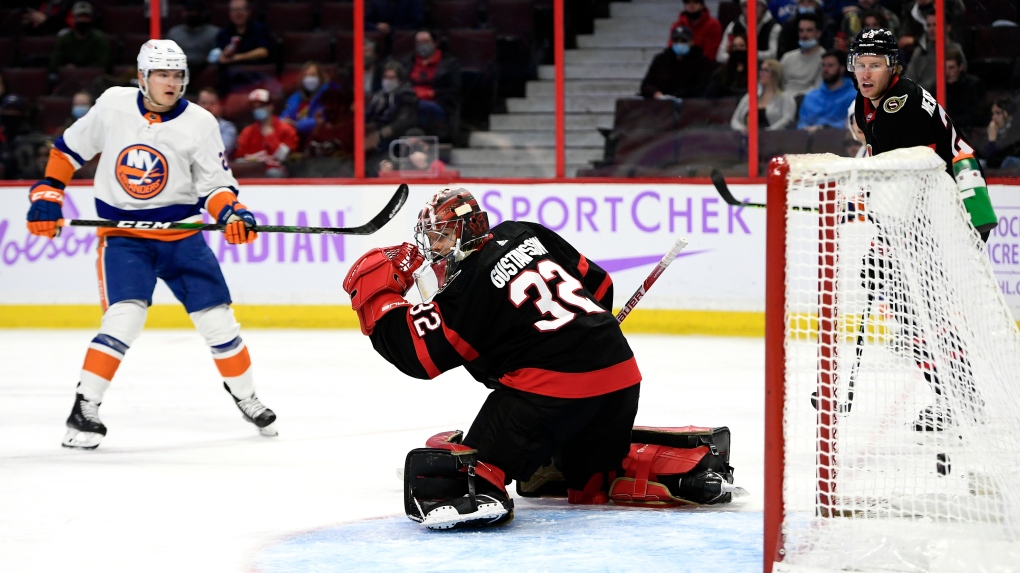 New York Islanders left wing Kieffer Bellows (20) watches a go shot in the net of Ottawa Senators goaltender Filip Gustavsson (32) during third period NHL hockey action in Ottawa, on Tuesday, Dec. 7, 2021. (THE CANADIAN PRESS/Justin Tang)