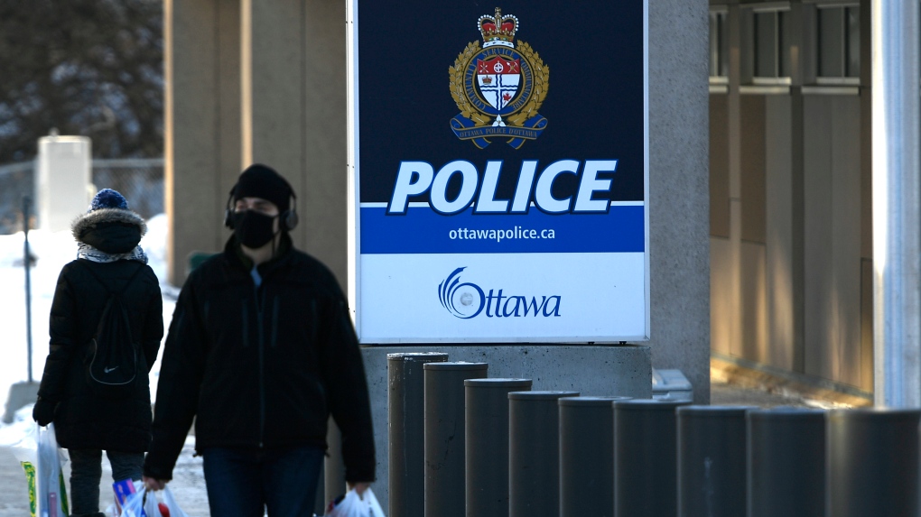 People pass the Ottawa Police station on Elgin Street in Ottawa, on Monday, Feb. 1, 2021. (Justin Tang/THE CANADIAN PRESS)