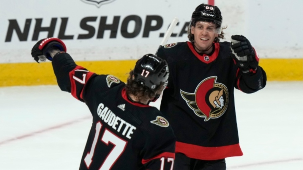 Senators centre Tyler Ennis, right, celebrates one of his three goals with teammate Adam Gaudette, left, during the first period of a 5-0 win over the Sabres on Tuesday in Ottawa. (Adrian Wyld/The Canadian Press)