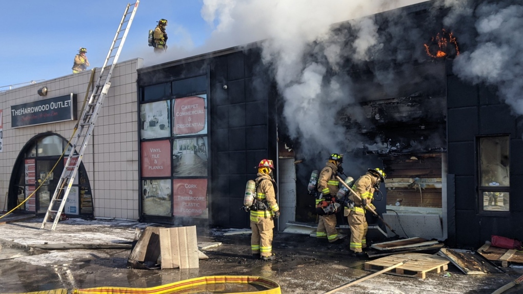 Ottawa firefighters battle a fire in a commercial strip on Colonnade Road South in Nepean. Jan. 8, 2022. (Photo via Scott Stilborn/@OFSFirePhoto/Twitter)