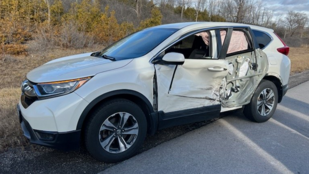 A driver was injured when the wheel of a tractor trailer came loose on Highway 401 and struck this vehicle Sunday, Dec. 4, 2022. (OPP/Twitter)
