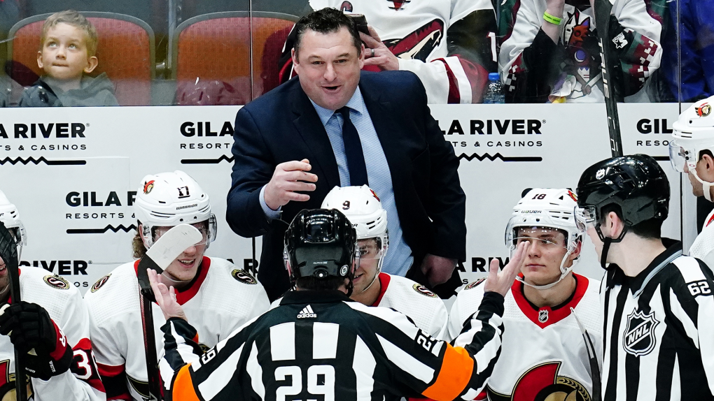Ottawa Senators head coach D.J. Smith, top, argues with referee Ian Walsh (29) as linesman Mitch Hunt (62) looks on while Senators' Adam Gaudette (17), Josh Norris (9), and Tim Stützle (18) listen in during the first period of an NHL hockey game Saturday, March 5, 2022, in Glendale, Ariz. (Ross D. Franklin/AP Photo) 