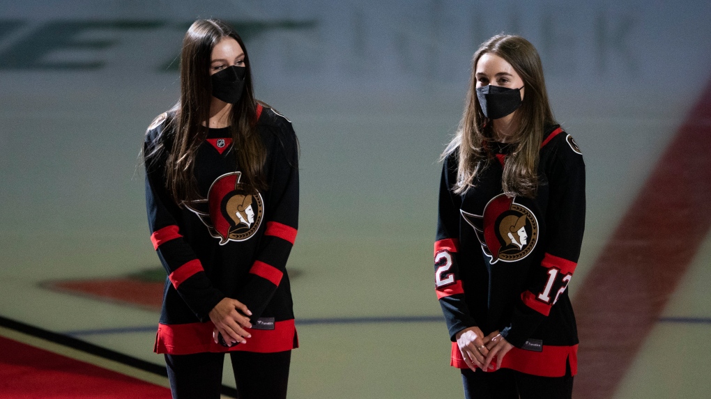 Anna, left, and Olivia Melnyk, daughters of late Ottawa Senators owner Eugene Melnyk, stand at centre ice for the ceremonial puck drop before an NHL hockey game between the Senators and the Florida Panthers in Ottawa on Thursday, April 28, 2022. Eugene Melnyk died on March 28 at the age of 62 after an illness. (Justin Tang/THE CANADIAN PRESS)