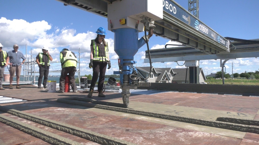 Crews work on the first two-storey, 3D printed house on Wolfe Island, near Kingston, Ont. (Kimberley Johnson/CTV News Ottawa)