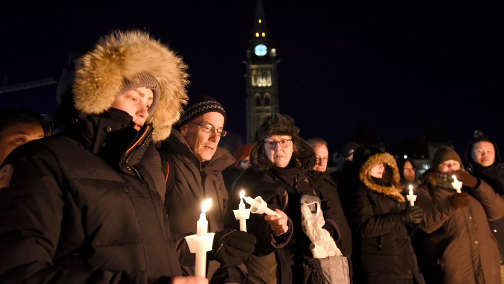 People light candles during a vigil on Parliament Hill, in response to the shooting at a Quebec City mosque on Sunday that killed six people, Monday, Jan. 30, 2017 in Ottawa. (Justin Tang/THE CANADIAN PRESS)