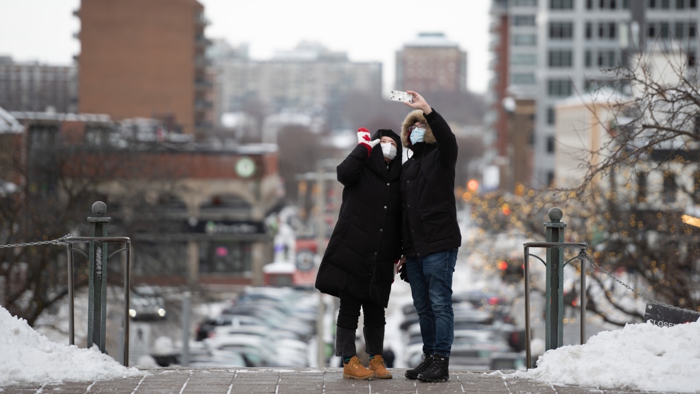 People take a Christmas Day selfie overlooking the ByWard Market in Ottawa, Sunday, Dec. 25, 2022. (Spencer Colby/THE CANADIAN PRESS) 