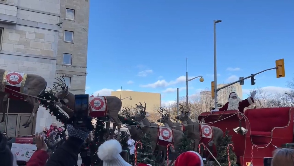Santa Claus waves to the crowd as the Help Santa Toy Parade travels along Laurier Avenue in Ottawa. (Leah Larocque/CTV News Ottawa)
