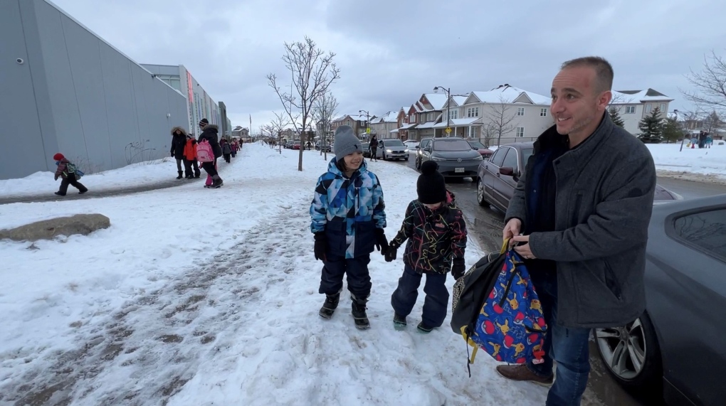 Fadi Mankal drops off his two children, Zane and Zya, at Half Moon Bay Public School in Barrhaven. Feb. 8, 2023. (Tyler Fleming / CTV News).