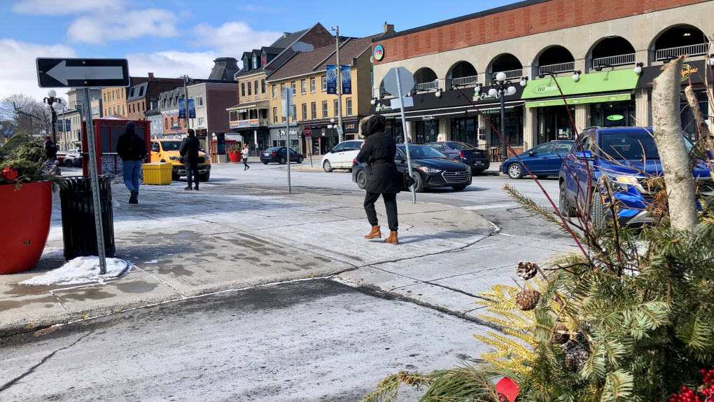 A pedestrian crosses the street in the ByWard Market. March 19, 2023. (Ted Raymond/CTV News Ottawa)