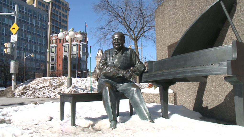 Snow surrounds the Oscar Peterson statue outside the National Arts Centre in Ottawa. (Jim O'Grady/CTV News Ottawa)