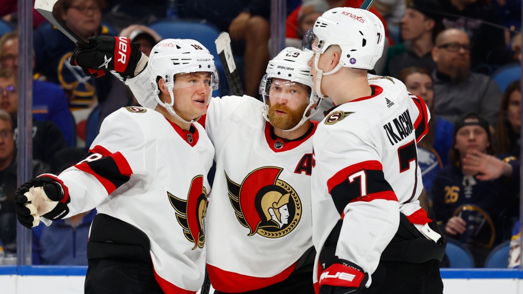 Ottawa Senators right wing Claude Giroux, center, celebrates his goal against the Buffalo Sabres with left wing Tim Stutzle (18) and left wing Brady Tkachuk (7) during the second period of an NHL hockey game Thursday, April 13, 2023, in Buffalo, N.Y. (AP Photo/Jeffrey T. Barnes)