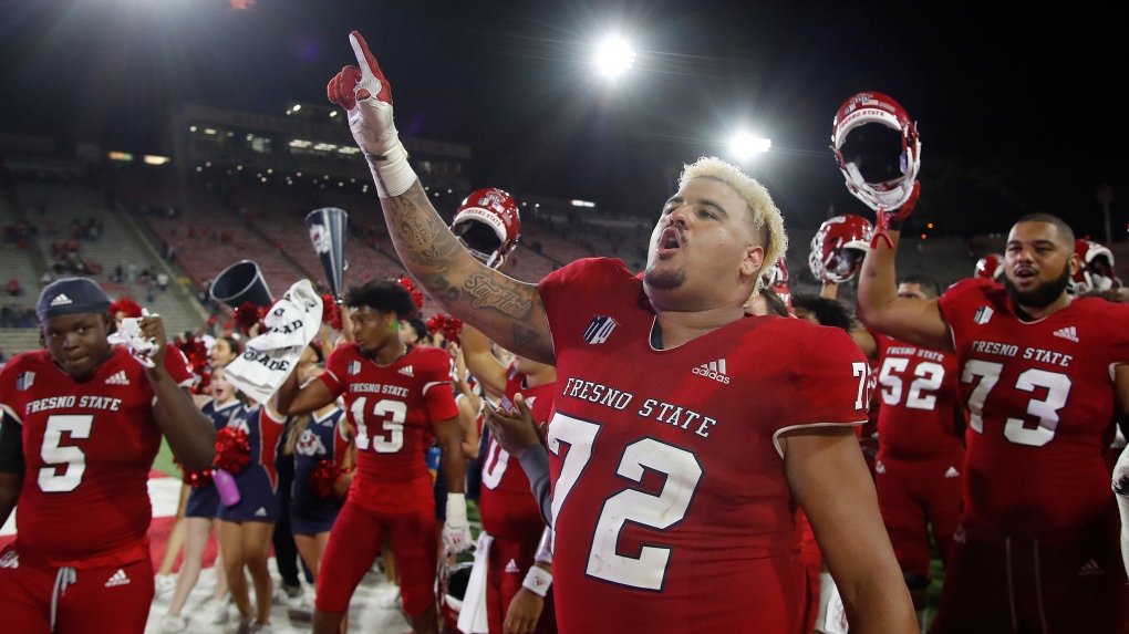 Fresno State offensive lineman Dontae Bull, foreground, celebrates a win over Nevada during the second half of an NCAA college football game in Fresno, Calif., Saturday, Oct. 23, 2021. (AP Photo/Gary Kazanjian)