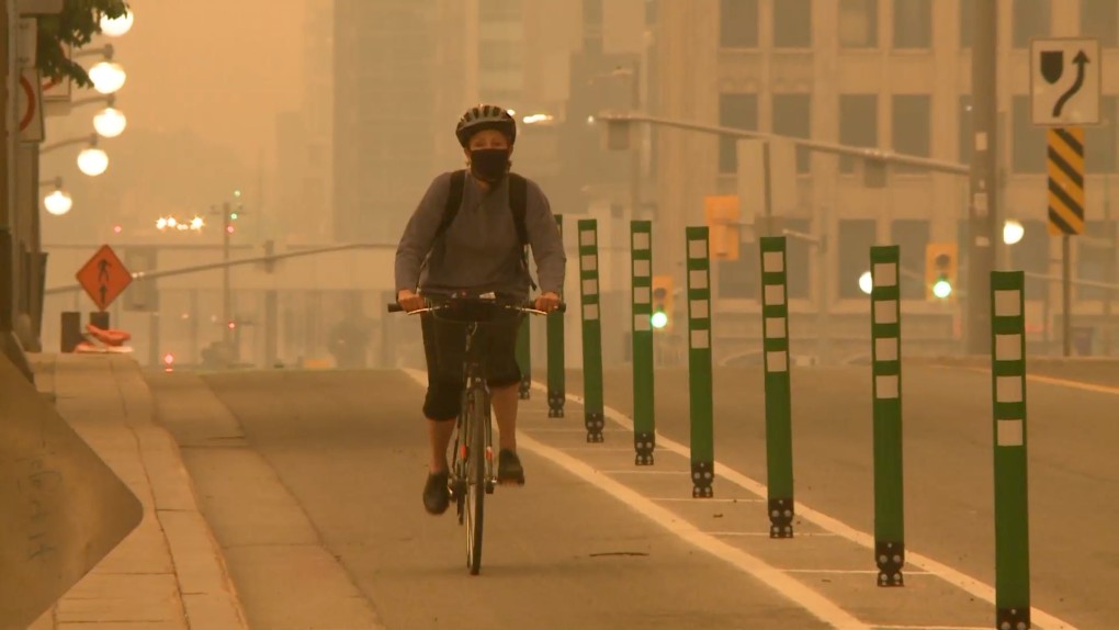 A cyclist rides through a smoky haze in Ottawa. June 6, 2023. (Jim O'Grady/CTV News Ottawa)