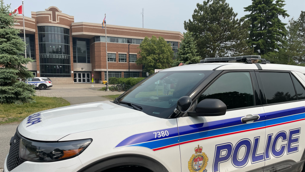 Ottawa police cruisers parked outside Holy Trinity Catholic High School in Kanata. The school says the front office received an anonymous call about someone with a weapon inside the school Wednesday morning on June 7, 2023. (Dave Charbonneau/CTV News Ottawa)