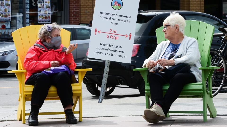 People take a rest in chairs in downtown Ottawa