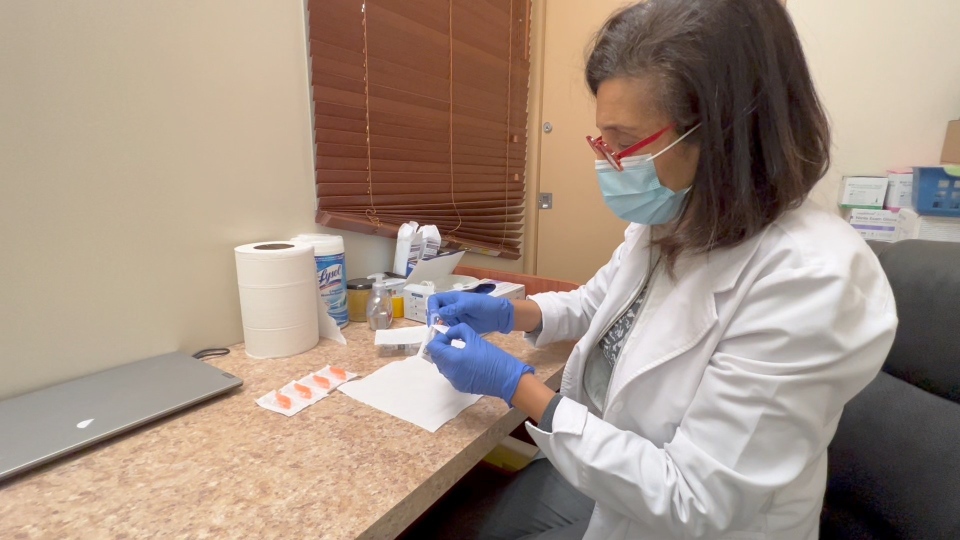 Heidi Gabriel preparing a flu shot in her pharmacy