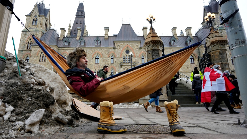 A man sits in a hammock on Parliament Hill